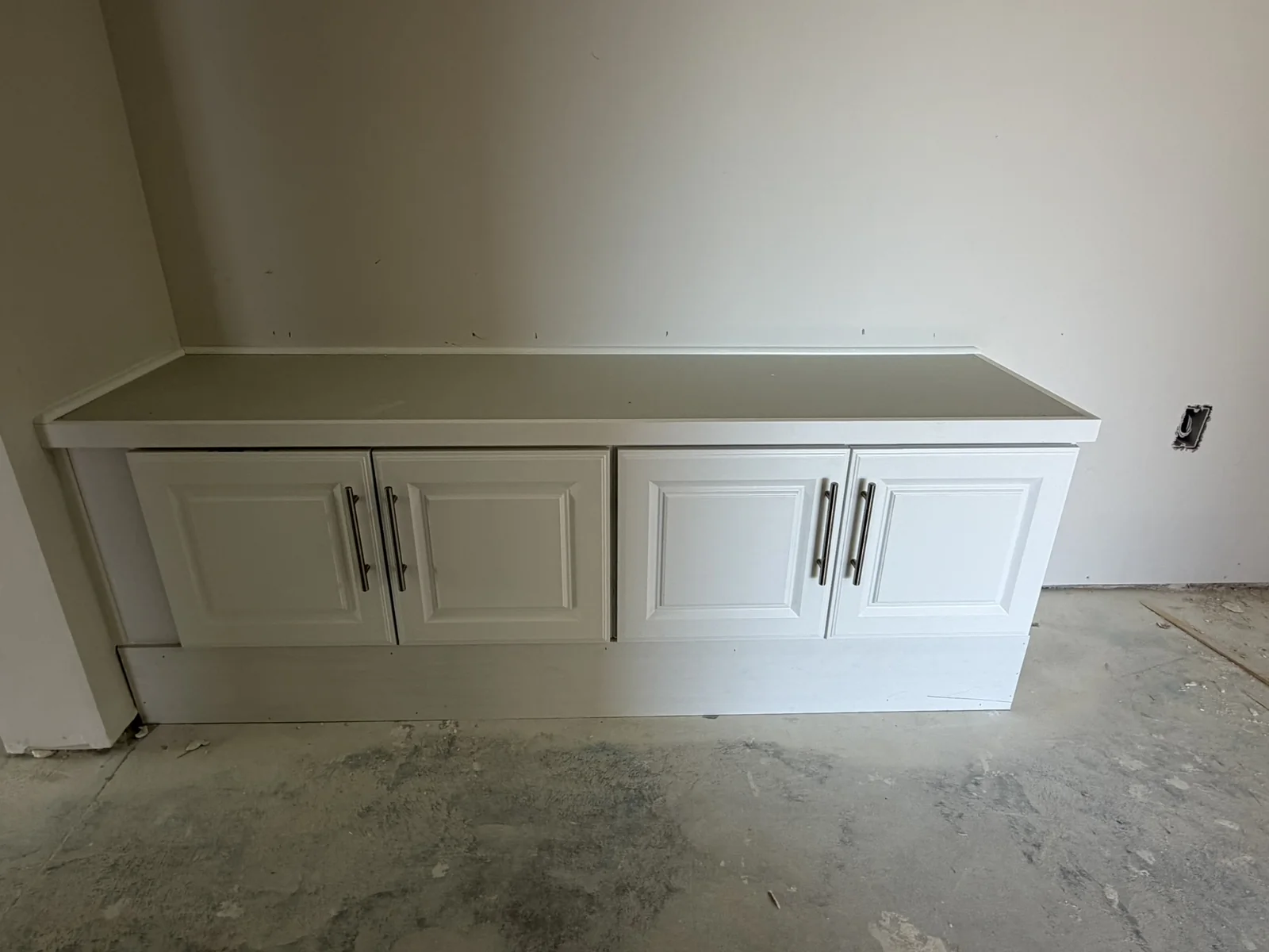 White storage cabinet run with doors, drawers and a fitted top